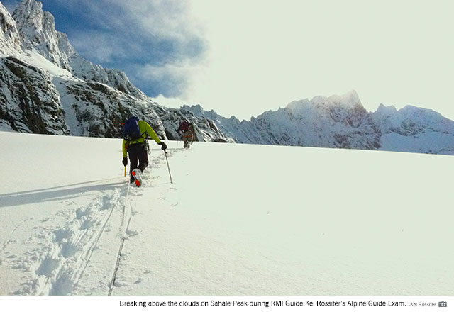 Breaking through the clouds on Sahale during RMI Guide Kel Rossiter's Alpine Guide Exam. 